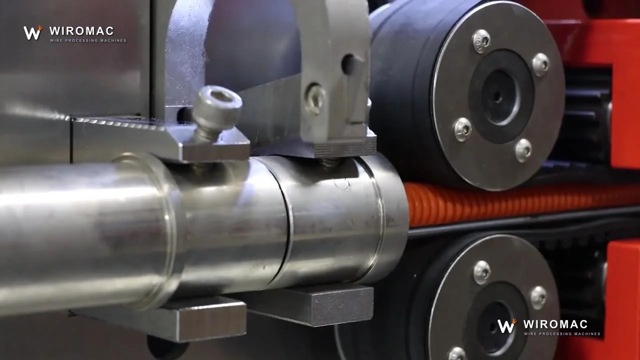 Flexible hose and corrugated tube through the feed wheels and blade.