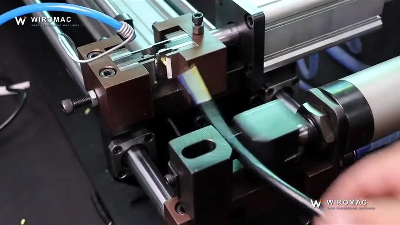 Bench pneumatic-electric stripper on a blue cable — insert, clamp, pull, done.