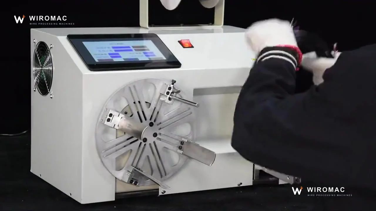Bench power-cord winding and tying — cord in, tied coil out.