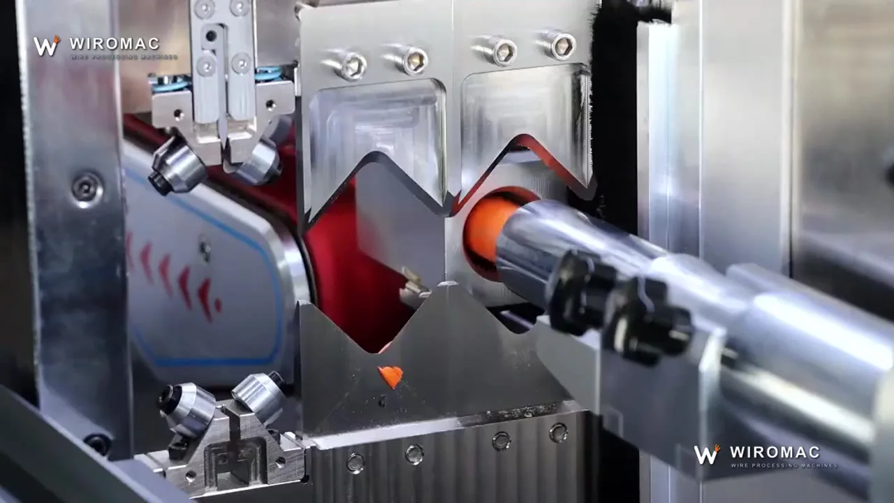 Rotary blade on an orange power jacket after belt feed — the ring cut that a V-blade cannot make.